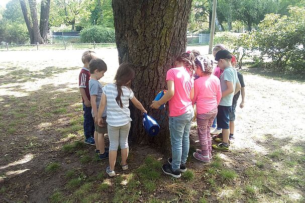 Kinder gießen Bäume